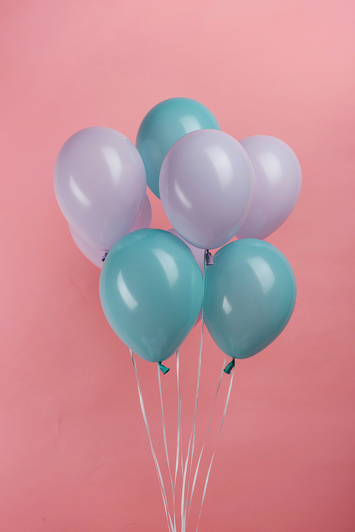 blue and purple party balloons on pink background