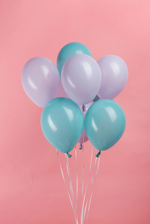 blue and purple festive balloons on pink background