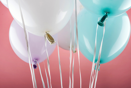 close up view of decorative colorful festive balloons on pink background