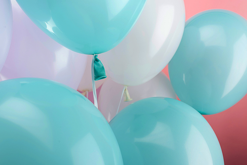 close up view of decorative festive balloons on pink background