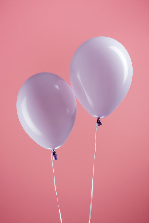purple decorative colorful balloons on pink background