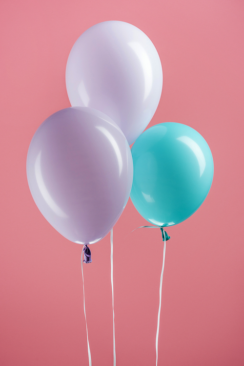 blue and purple colorful decorative balloons on pink background