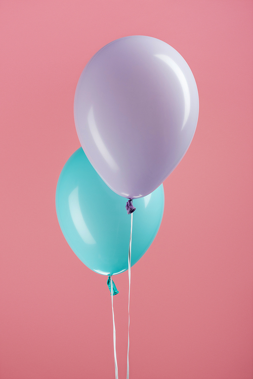 blue and purple decorative festive balloons on pink background