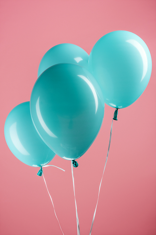 blue colorful decorative festive balloons on pink background
