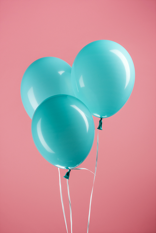 blue decorative festive balloons on pink background