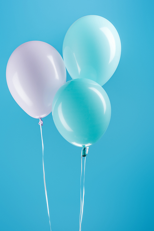 purple and blue festive balloons on blue background
