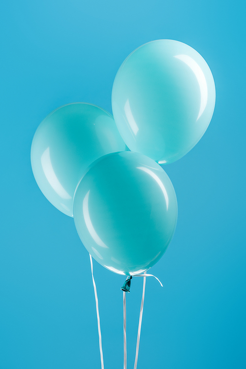 minimalistic blue decorative balloons on blue background
