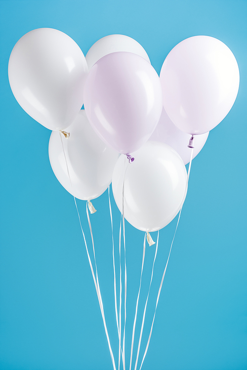 decorative white party balloons on blue background