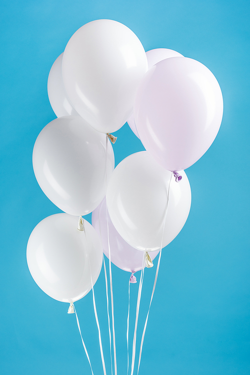white festive balloons on colorful blue background