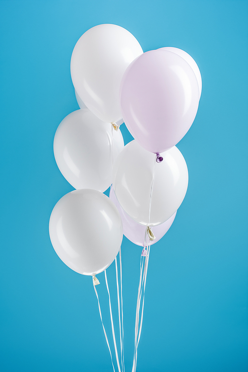 white decorative balloons on colorful blue background