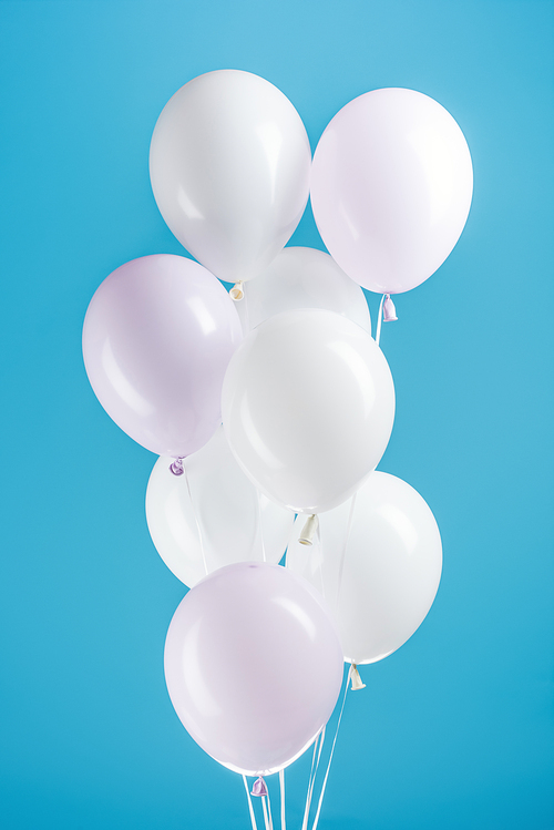 white party balloons on colorful blue background