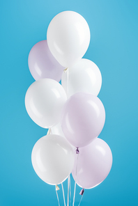 white decorative party balloons on colorful blue background