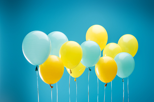 colorful yellow and blue balloons on blue background
