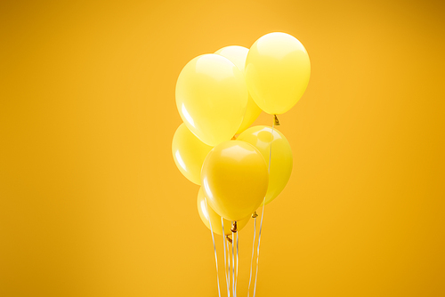 colorful minimalistic decorative balloons on yellow background