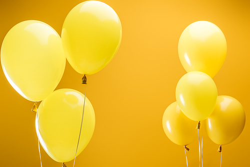festive bright minimalistic balloons on yellow background
