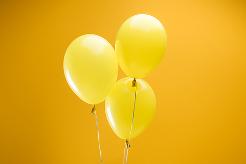 festive colorful minimalistic decorative balloons on yellow background