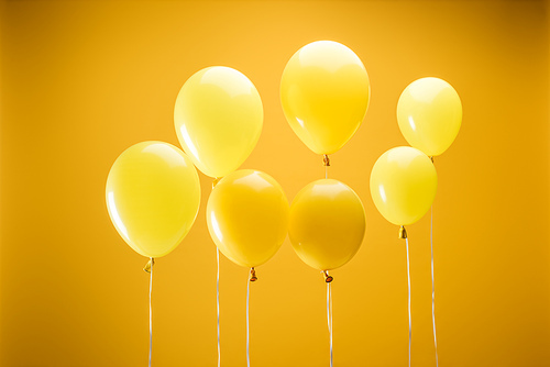 festive minimalistic decorative balloons on yellow background