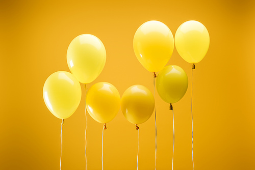 bright minimalistic decorative balloons on yellow background