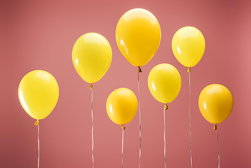 yellow balloons on pink background, party decoration