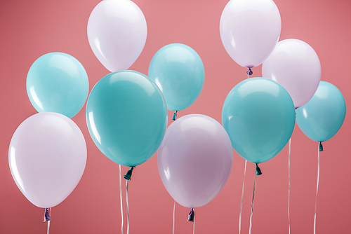 multicolored party decorative balloons on pink background