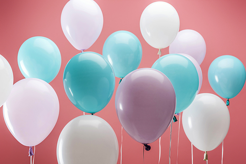bright multicolored decorative balloons on pink background