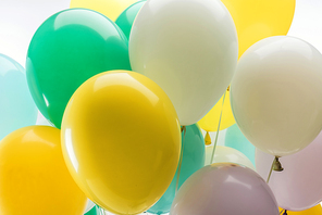 close up view of bright green, yellow and blue decorative balloons