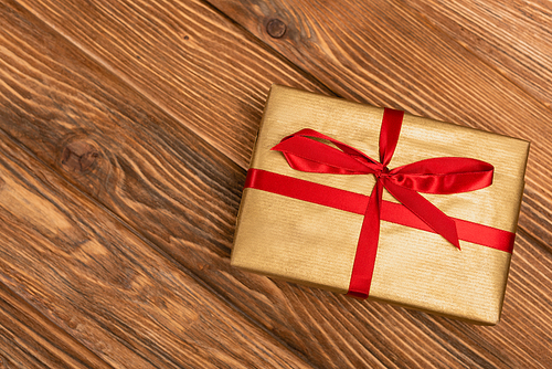 top view of wrapped present on wooden background