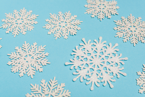 top view of winter snowflakes on blue background