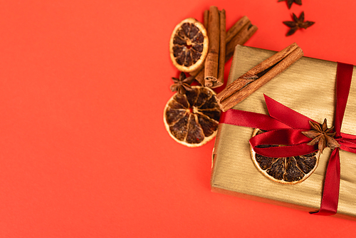 top view of gift with spices on red background