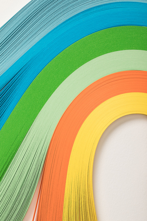 close up of wavy rainbow paper lines on grey background