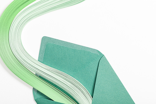 close up of green envelope with multicolored rainbow on white background