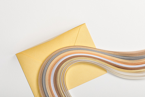 yellow envelope with multicolored paper lines on grey background