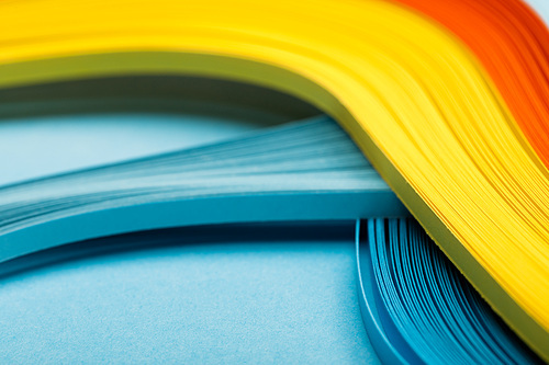 close up of yellow, orange and blue abstract bright lines on blue background