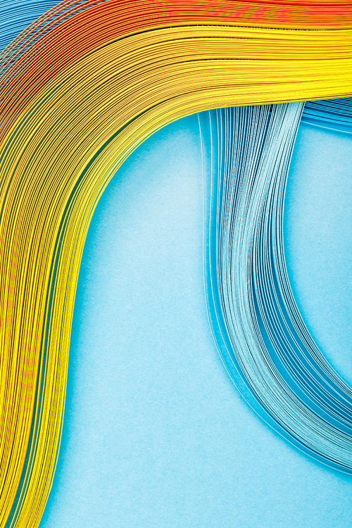 top view of yellow, orange and blue lines on blue background