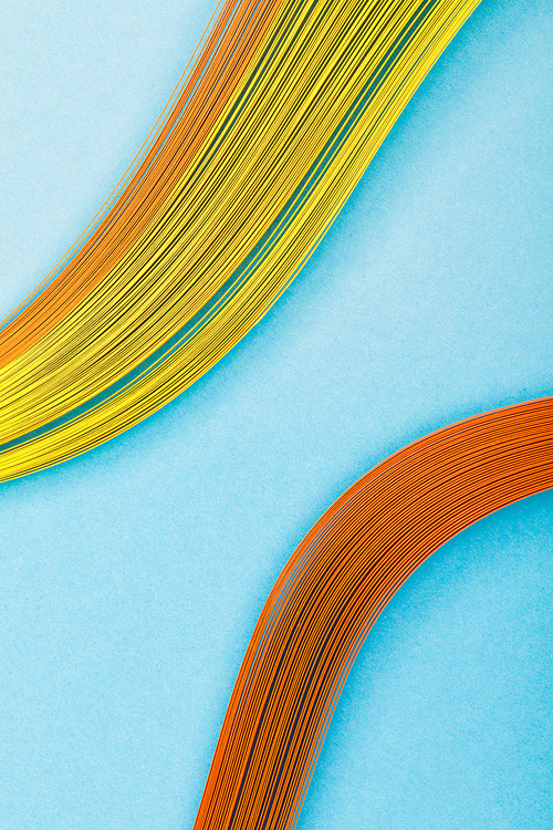 close up of multicolored abstract lines on blue background