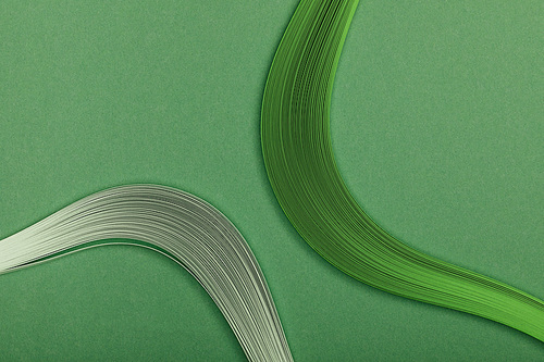 close up of grey and green abstract lines on green background