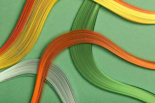 close up of multicolored bright abstract lines on green background