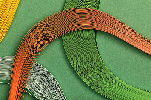 close up of multicolored lines on green background