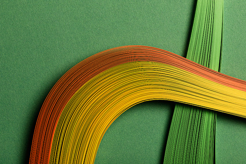 close up of multicolored abstract lines on green background