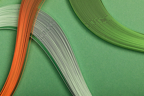 close up of colorful abstract lines on green background