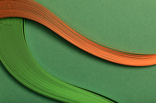 close up of green and orange abstract lines on green background