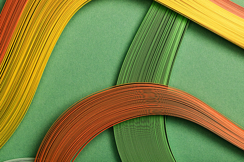 close up of multicolored abstract lines on green background