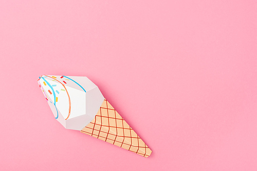 top view of handmade paper ice cream cone isolated on pink with copy space