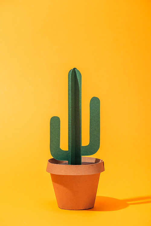 handmade green paper cactus in flower pot on orange
