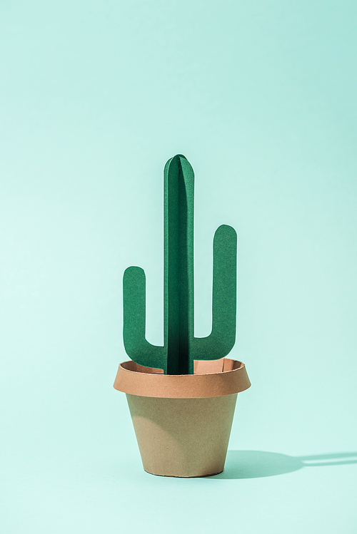 handmade green paper cactus in flower pot on turquoise