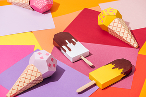 various handmade origami ice cream on multicolored paper