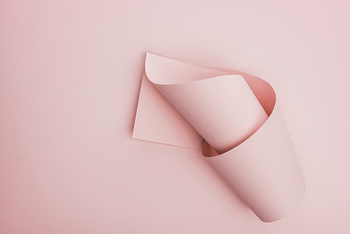 top view of pink paper swirl on pink background