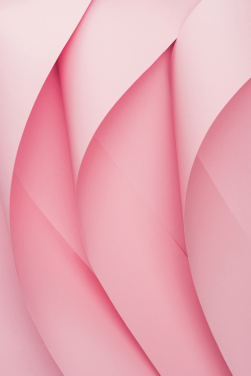 top view of pink paper swirls on pink background
