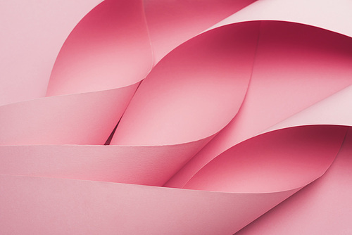 abstract of pink paper swirls on pink background