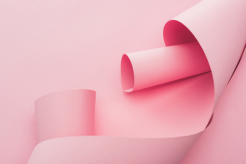 abstract pink paper swirls on pink background